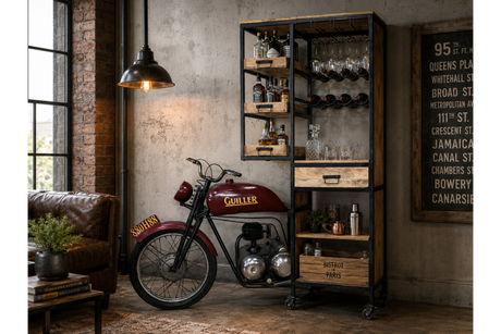 Motorbike-shaped bar cabinet in black metal and wood with shelves, drawers, and glass racks in a vintage living room setting.