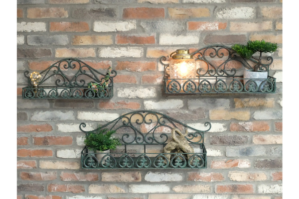 Set of 3 green wrought iron wall shelves with decorative scrollwork, displayed on a brick wall with small plants and