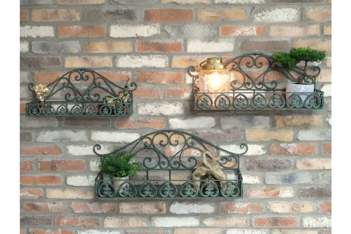 Set of 3 green wrought iron wall shelves with decorative scrollwork, displayed on a brick wall with small plants and