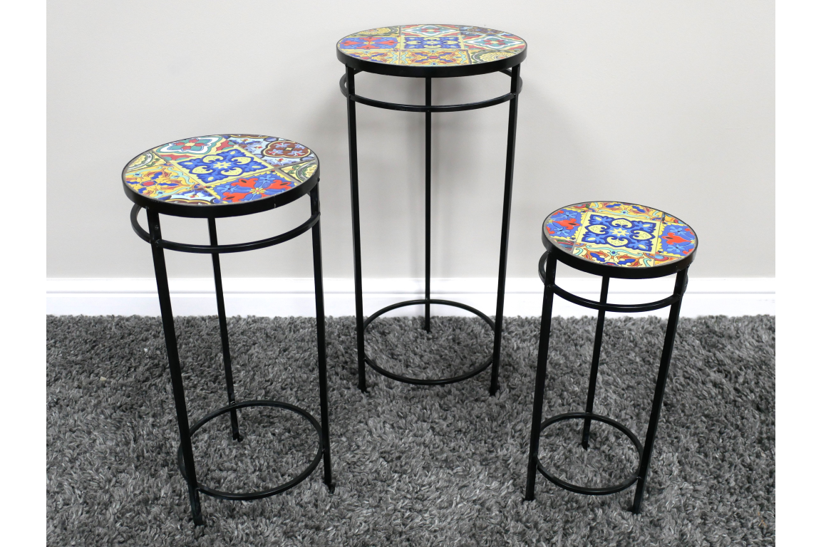 Set of 3 round side tables with black metal frames and colorful mosaic tile tops on gray carpet.