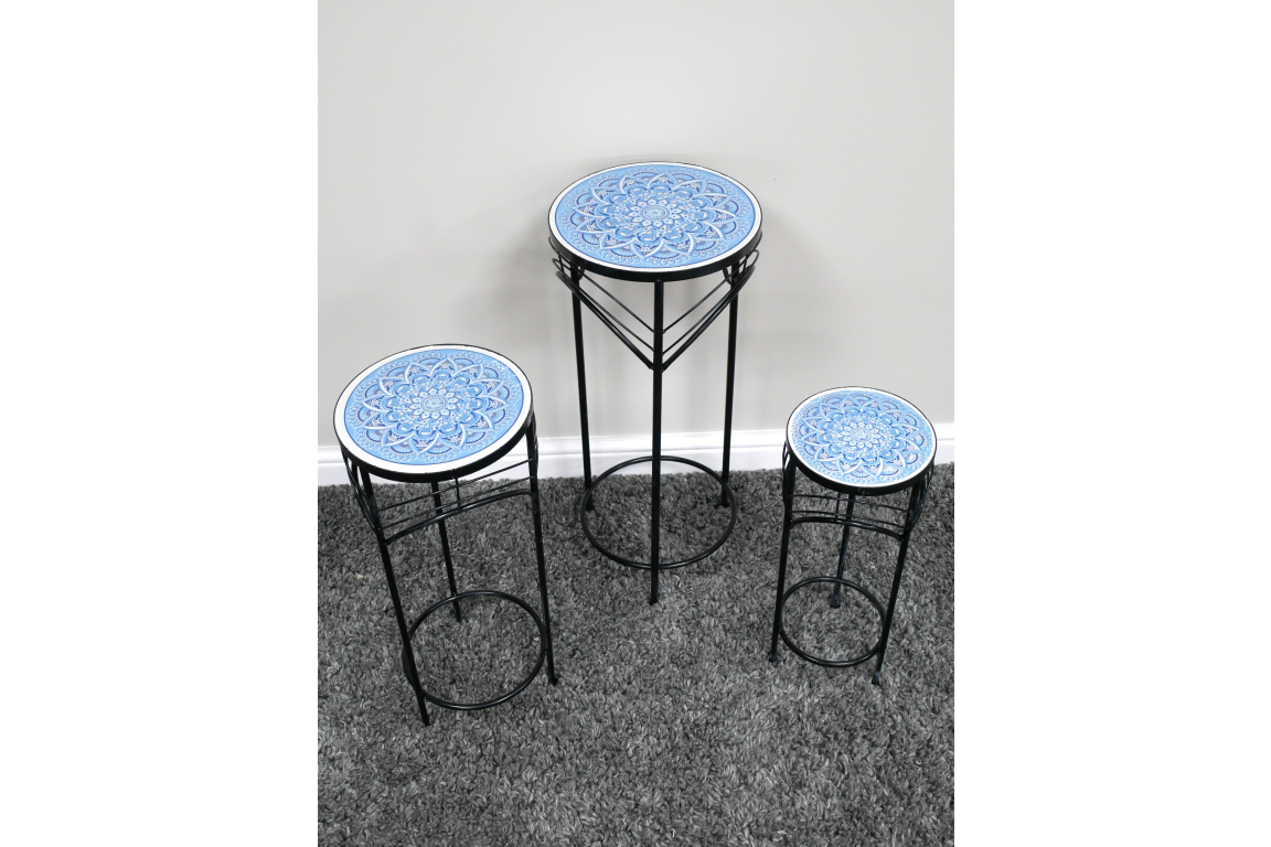 Set of 3 round side tables with blue patterned ceramic tops and black metal legs on gray carpet.