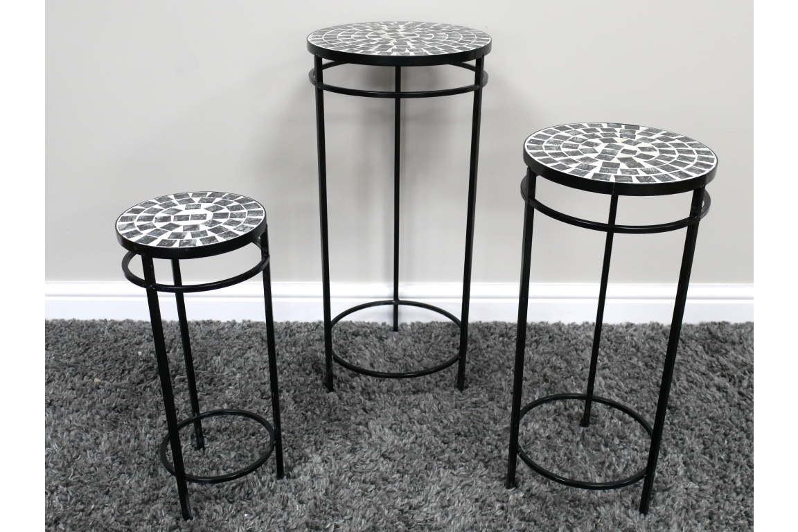 Set of 3 round black metal side tables with mosaic tile tops in varying heights on a gray carpet.