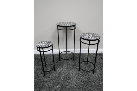 Set of 3 side tables with black metal frames and round mosaic tops in black and white, displayed on grey carpet.