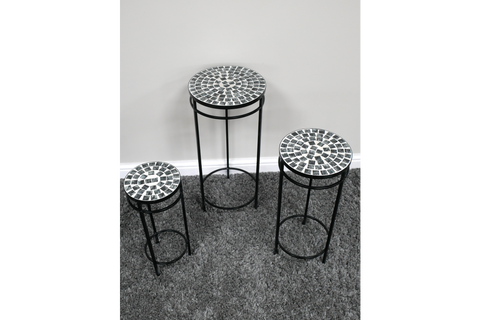 Set of 3 round side tables with black metal frames and mosaic tile tops in black and white on gray carpet.