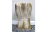 Abstract sculptural side table in textured gold and silver metallic finish, shown from the front on a gray rug.