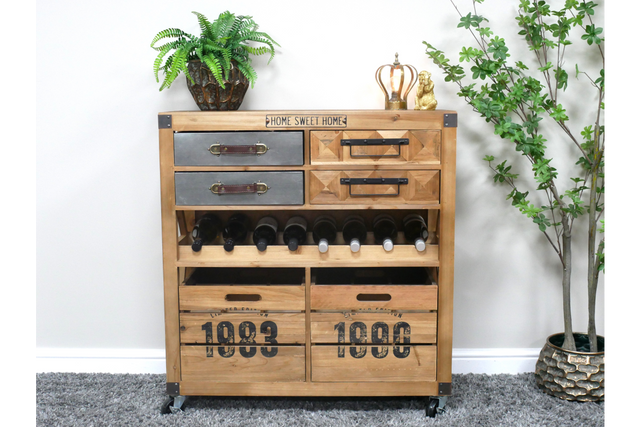 Wooden wine cabinet with metal and wood drawers, open bottle rack, and numbered crate compartments, shown in a room setting.