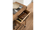 Wooden wine cabinet drawer open showing four metal spoons and two cans of soda, angled top view.