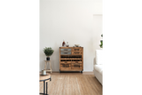 Wooden wine cabinet with metal accents, drawers, shelves, and wheels in a modern living room setting.