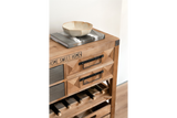 Wooden wine cabinet with drawers, black metal handles, wine bottle storage, and decorative bowl on top, angled view.