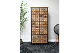 Wooden storage cabinet with multiple small drawers, black metal frame, shown front view on gray shaggy rug.