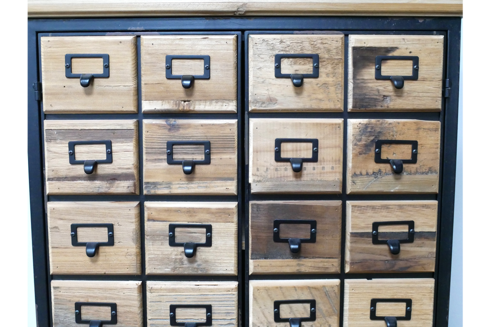 Storage cabinet with sixteen small wooden drawers featuring black metal handles and label holders, front view.