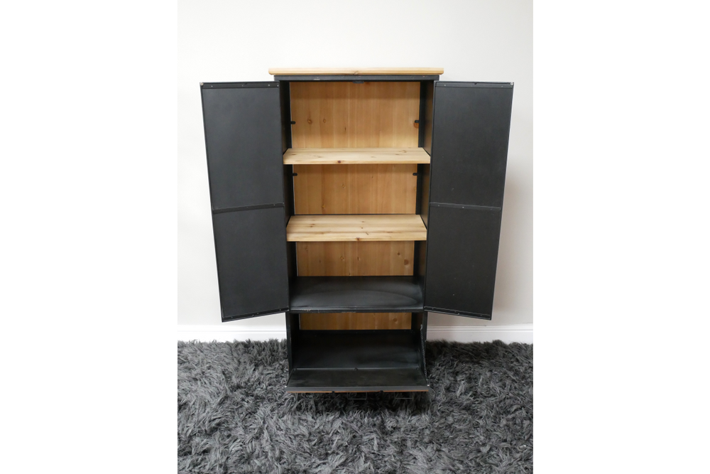 Black metal storage cabinet with light wood shelves, open doors, standing on gray carpet against white wall.