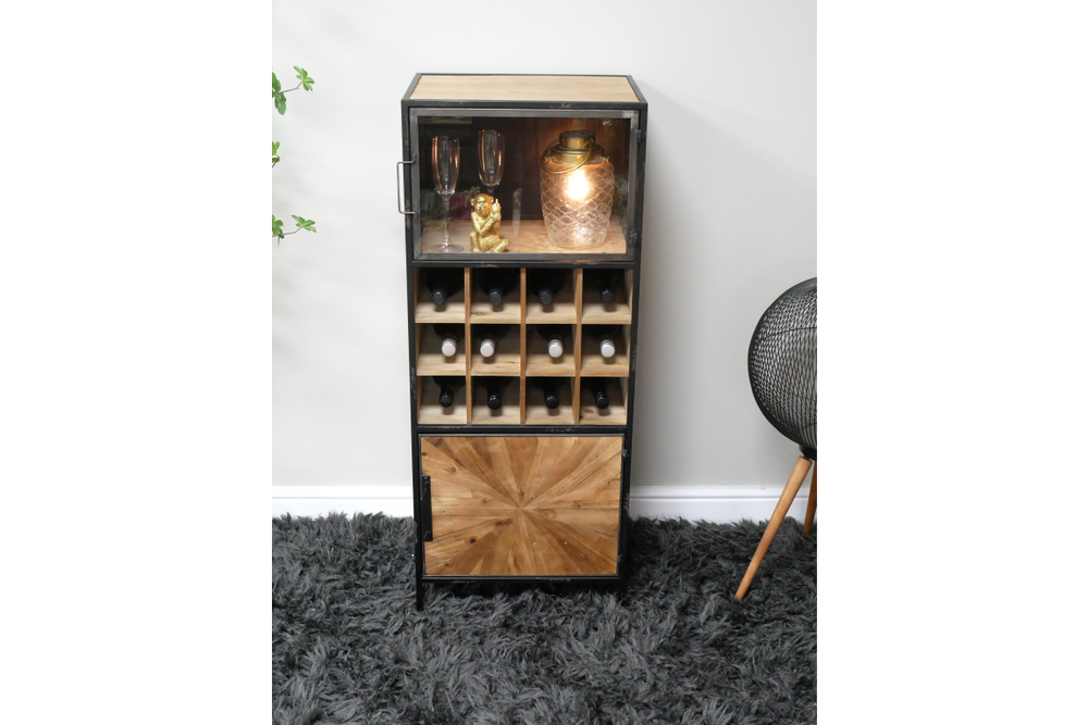 Tall wine cabinet with black metal frame, light wood shelves and decorative door, displayed on gray carpet.