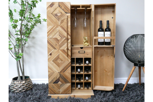 Wooden wine cabinet with geometric patterned door, multiple bottle slots, glass holders, and a small drawer, shown open.