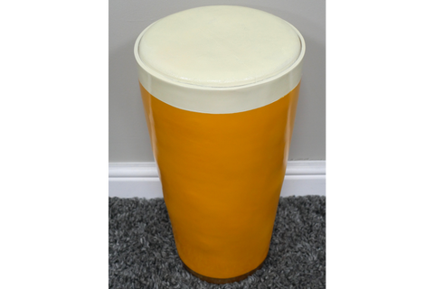 Cylindrical Lager Side Table with glossy yellow base and white round cushioned top, shown from above on gray carpet.