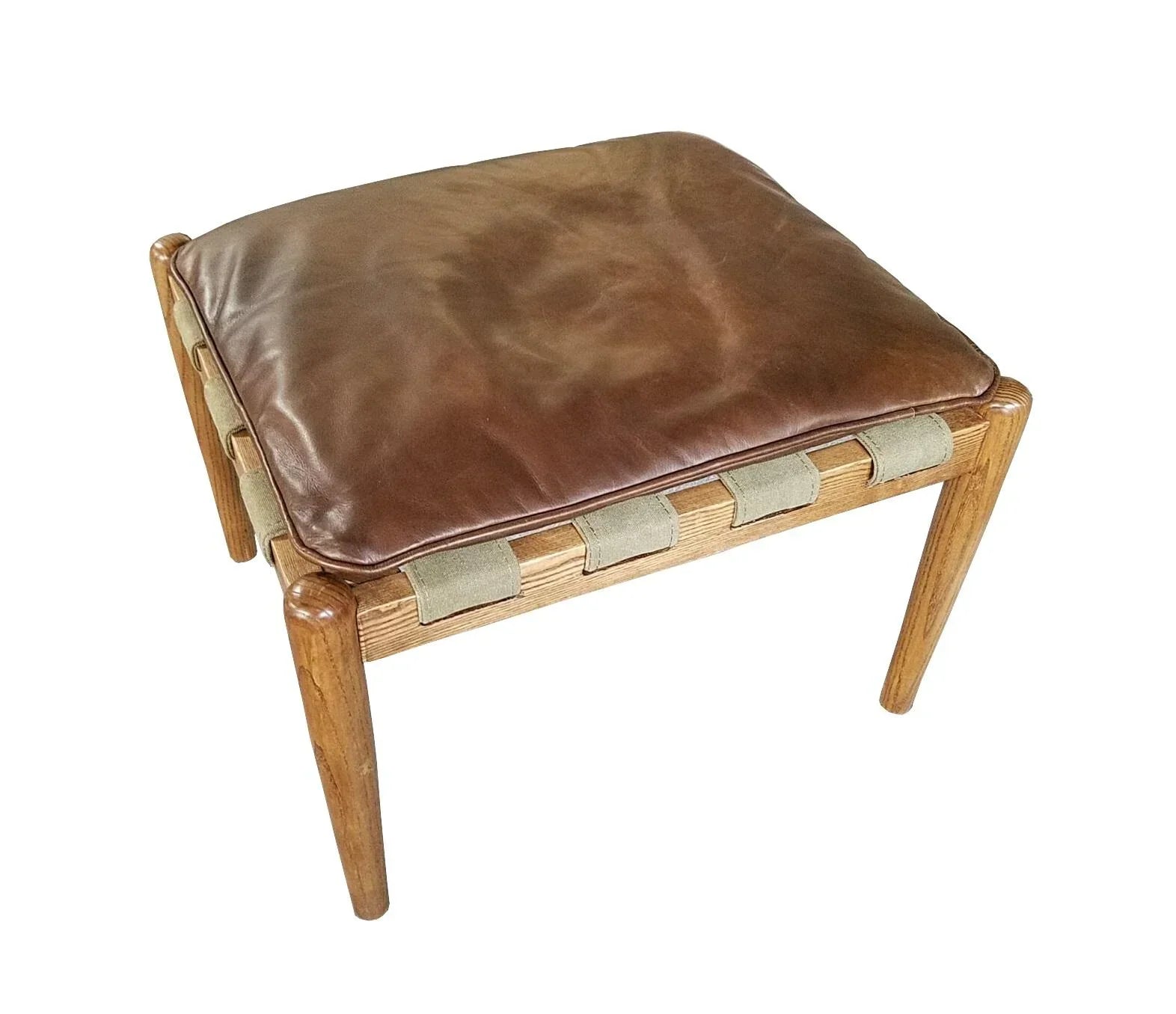 Brown leather ottoman with wooden frame and woven strap detail, angled view