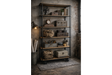 Tall shelving unit on black metal wheels with wooden shelves, styled with vintage items in industrial setting.