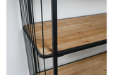 Close-up angled view of wooden shelves with black metal frame and vertical bars on wheels.