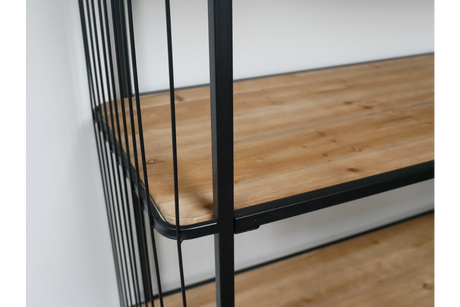Close-up angled view of wooden shelves with black metal frame and vertical bars on wheels.
