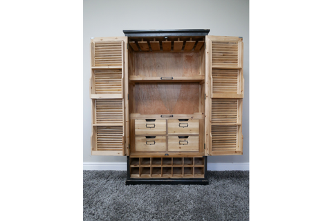 Wooden shutter bar cabinet with natural and black finish, open front showing shelves, drawers, and bottle slots, front view.