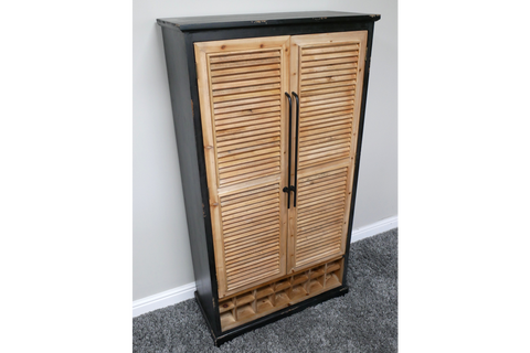 Tall shutter bar cabinet with natural wood louvered doors, black frame, metal handles, and built-in wine rack, angled view.