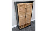 Tall shutter bar cabinet with natural wood louvered doors, black frame, metal handles, and built-in wine rack, angled view.