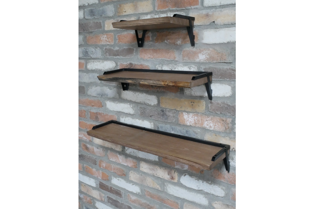 Set of 3 wooden wall shelves with black metal brackets mounted on a rustic brick wall, angled side view.