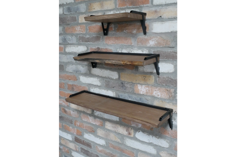 Set of 3 wooden wall shelves with black metal brackets mounted on a rustic brick wall, angled side view.