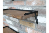 Set of 3 rustic wood wall shelves with black metal frame brackets, mounted on exposed brick wall, angled side view.