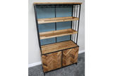 Bar cabinet with black metal frame, natural wood shelves and herringbone wood doors, angled view on gray carpet.