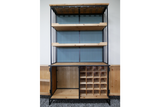 Tall bar cabinet with black metal frame, natural wood shelves, wine bottle slots, and ribbed blue back panel, front view.