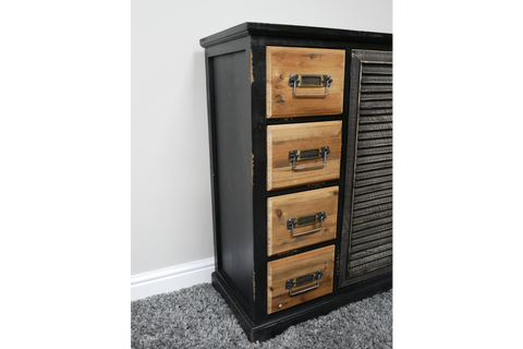 Black wooden sideboard with natural wood drawers and metal handles, shown from a front side angle on carpet.