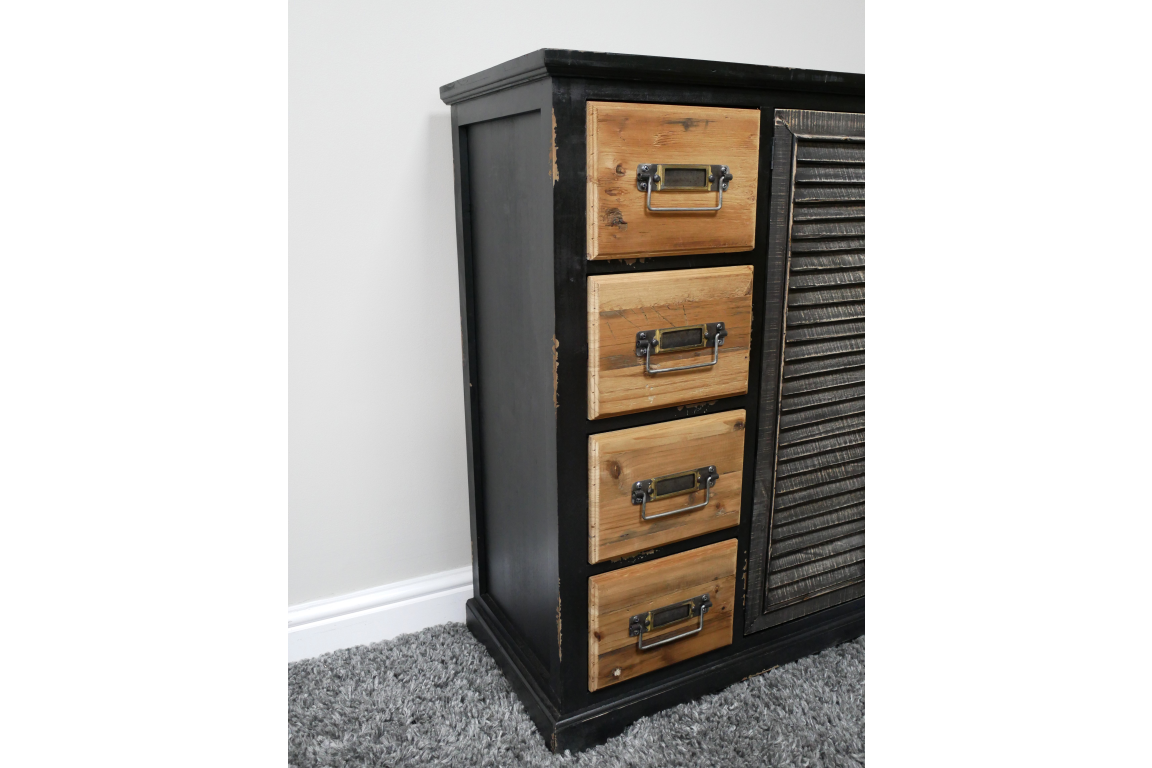 Black wooden sideboard with natural wood drawers and metal handles, shown from a front side angle on carpet.