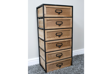 Tall industrial drawer cabinet with six natural wood drawers and black metal frame, angled view on gray carpet.