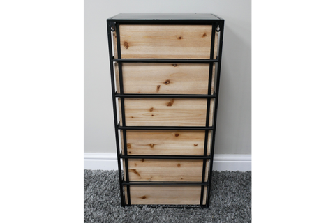 Industrial drawer cabinet with five light wood drawers and black metal frame, front view on carpeted floor.