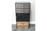 Tall industrial drawer cabinet with metal top drawers, a central black metal door, and two wooden bottom drawers on gray