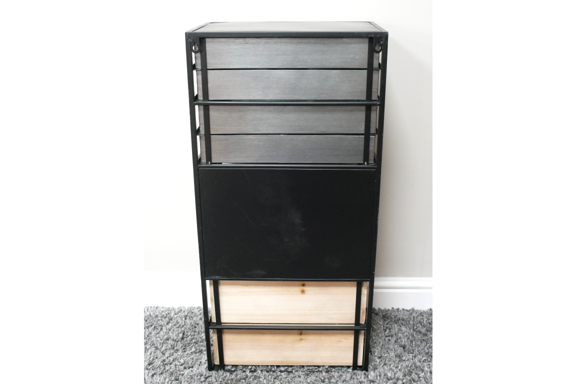 Industrial drawer cabinet with black metal frame, gray and light wood drawers, front view on gray carpet background.
