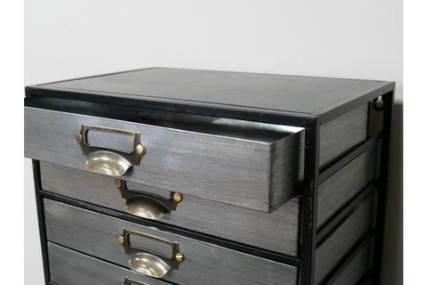 Metal industrial drawer cabinet with five drawers, brass handles, shown from front angle with one drawer open.