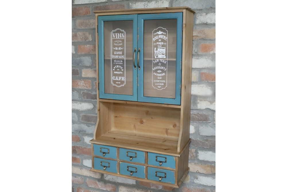 Wooden wall unit with natural finish and distressed blue cabinet doors and drawers, front view against brick wall.