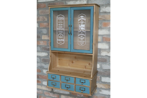 Wooden wall unit with natural finish and distressed blue cabinet doors and drawers, front view against brick wall.