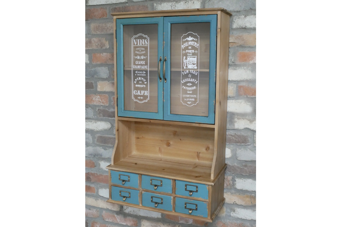 Wooden wall unit with natural finish and distressed blue cabinet doors and drawers, front view against brick wall.