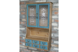 Wooden wall unit with natural finish and distressed blue cabinet doors and drawers, front view against brick wall.
