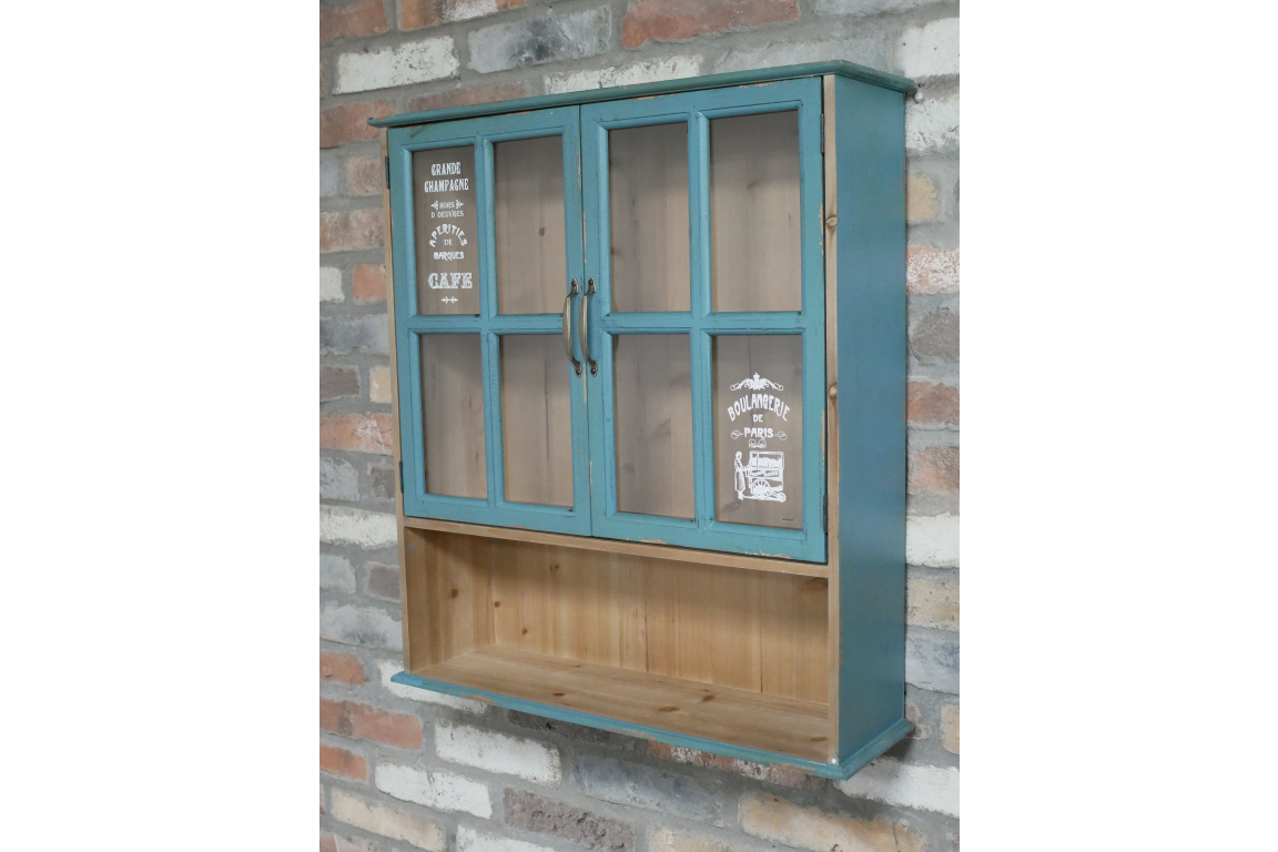 Blue wooden Parisienne Wall Unit with glass paneled doors and open lower shelf, mounted on brick wall.