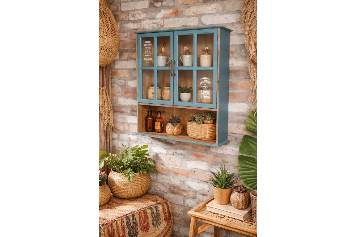 Wall-mounted wooden kitchen unit in distressed blue with glass paneled doors, displayed at an angle against a brick wall.