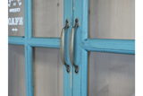 Close-up of blue painted wooden wall unit doors with metal handles and glass panels.