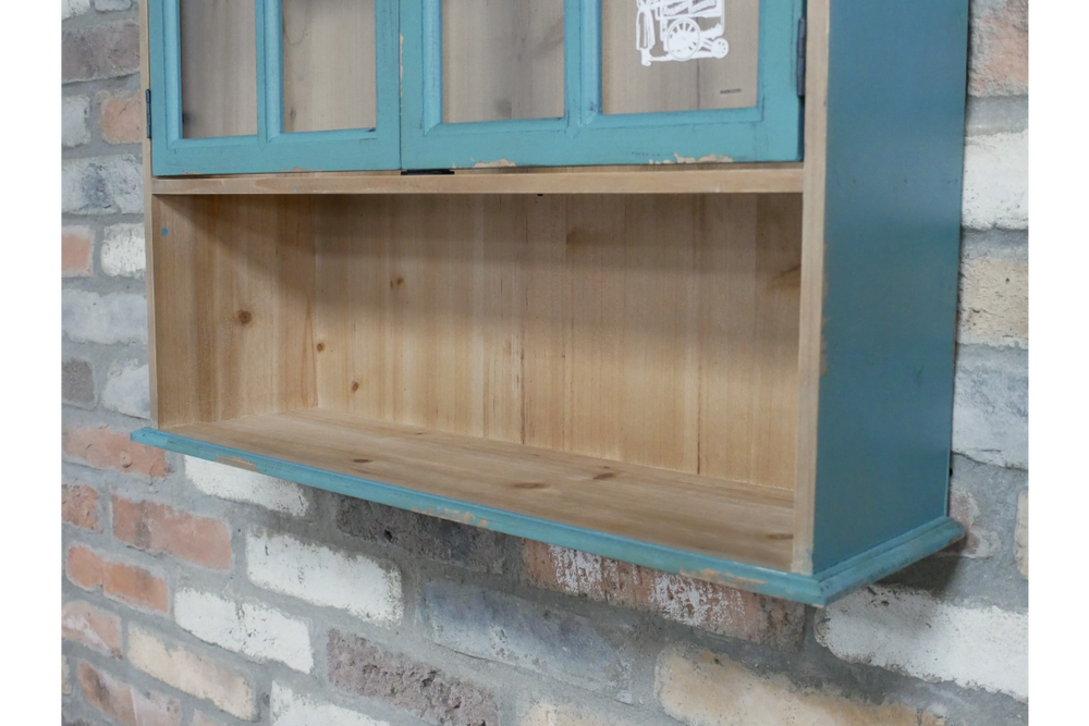 Parisienne wall unit in natural wood and distressed teal paint, close-up angled view against brick wall background.