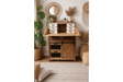 Rustic wooden cabinet with small white drawers, black metal handles, and a folding top panel in a boho room setting.