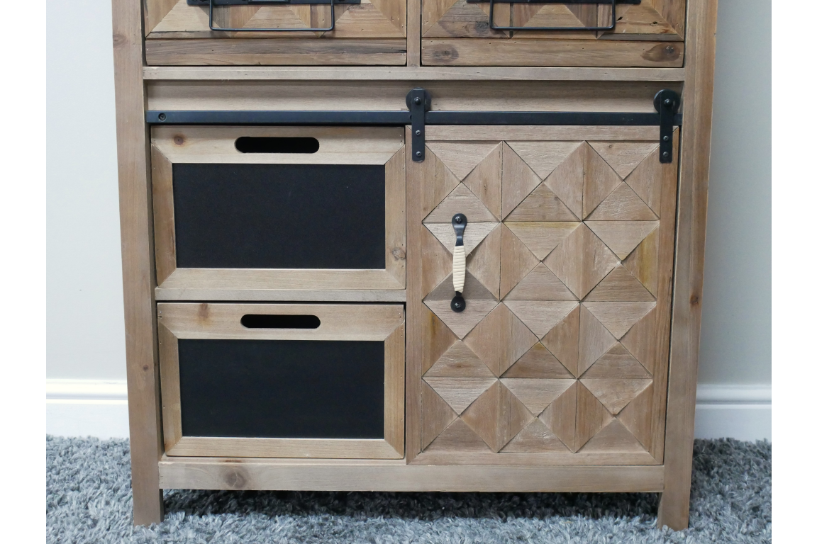 Rustic wooden cabinet with geometric patterned door, two black drawer fronts, metal handle, and sliding rail, front view.