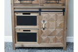 Rustic wooden cabinet with geometric patterned door, two black drawer fronts, metal handle, and sliding rail, front view.