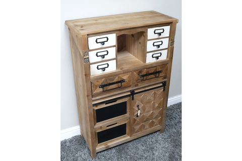 Rustic wooden cabinet with multiple drawers, white and wood finishes, black handles, and a textured door, angled view.